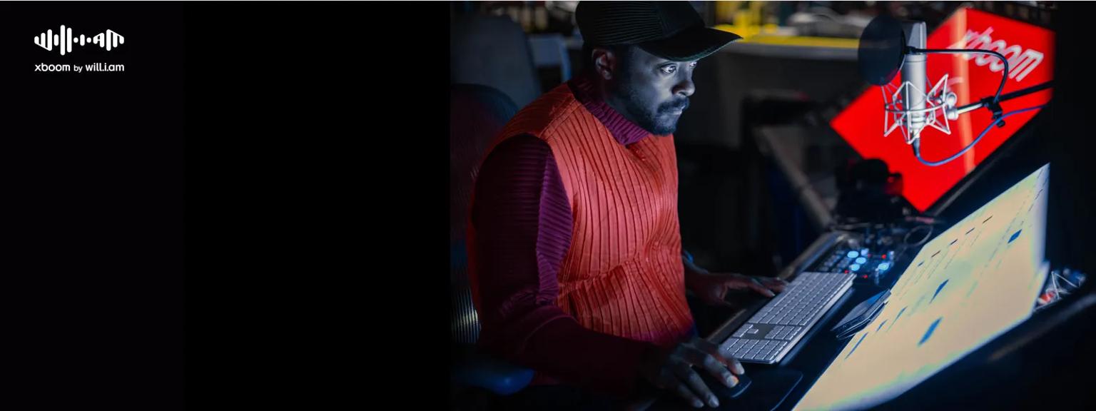 Will.i.am sitting in the studio tuning music